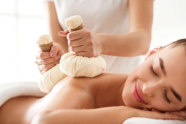 Herbal massage. Masseur doing massage for deep relaxation