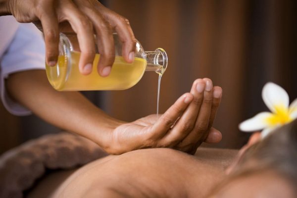 therapist-pouring-massage-oil-at-spa.jpg